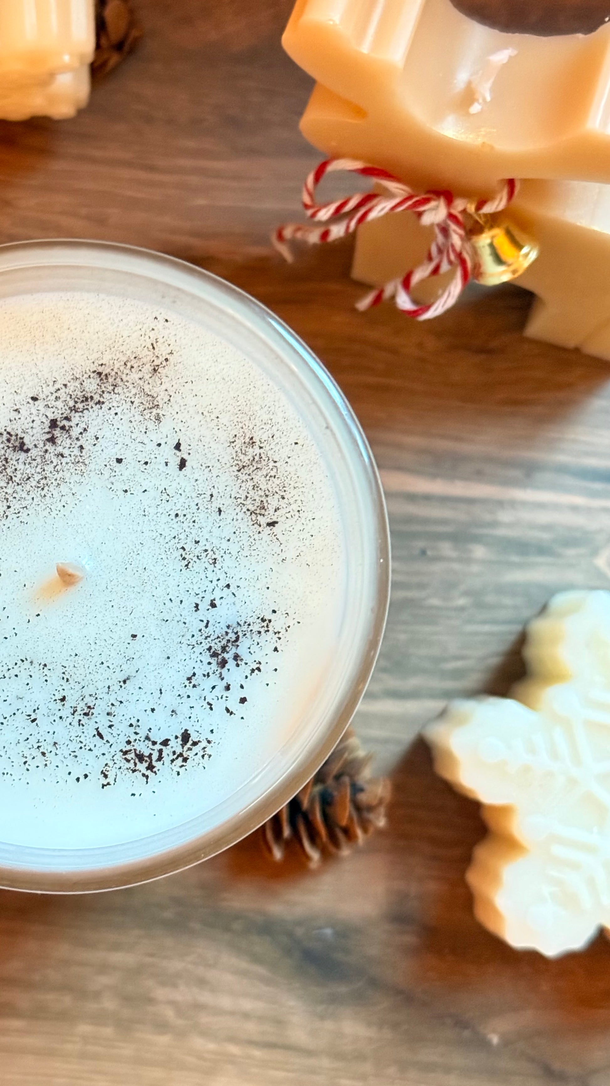 Close-up of a frothy beverage with a decorative item on a wooden surface