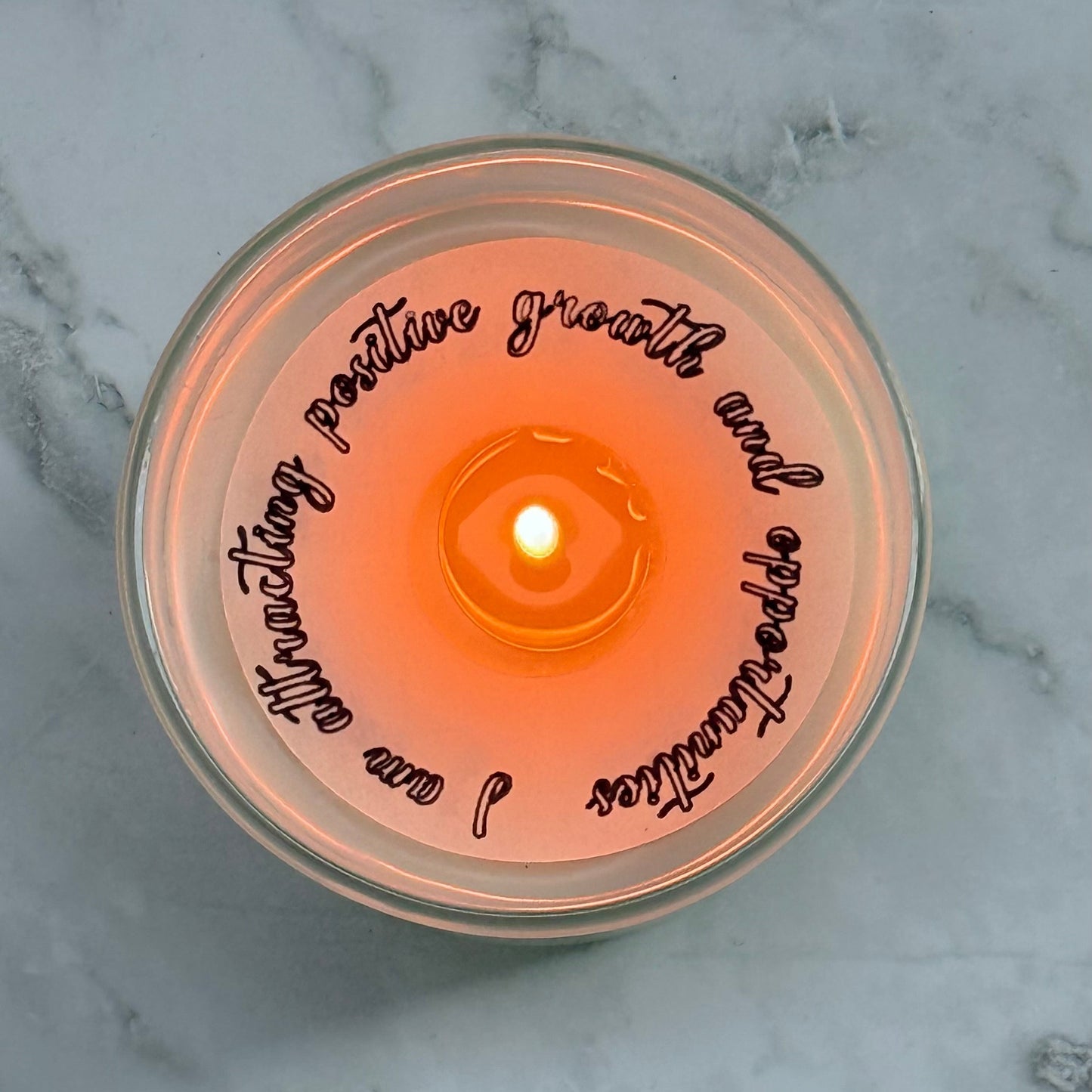Candle with text on a marble surface