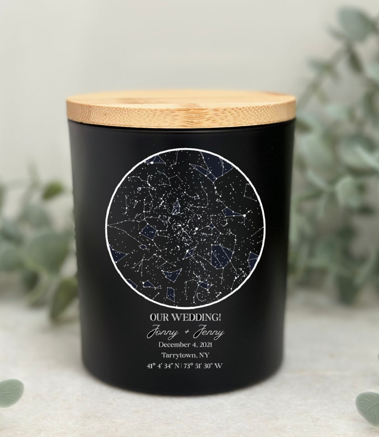 Black candle with a wooden lid featuring a celestial design and text on a light background.