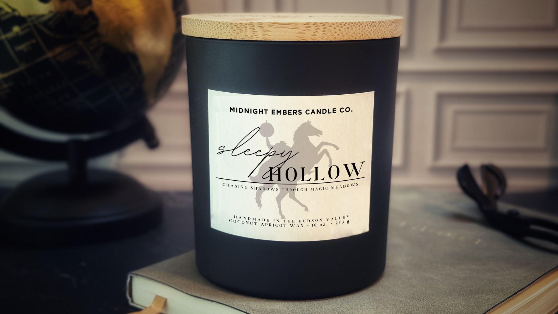 Black candle with a wooden lid and 'Sleepy Hollow' label on a surface.